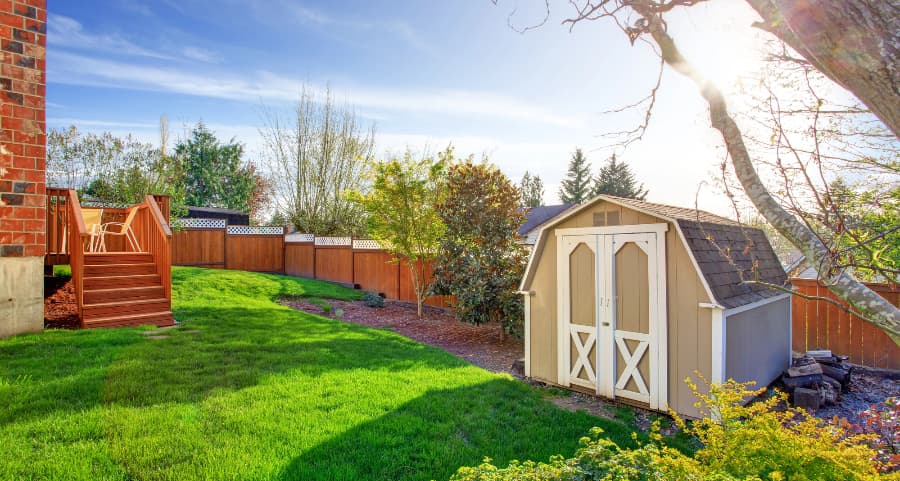 Fenced backyard with storage shed in Newburgh